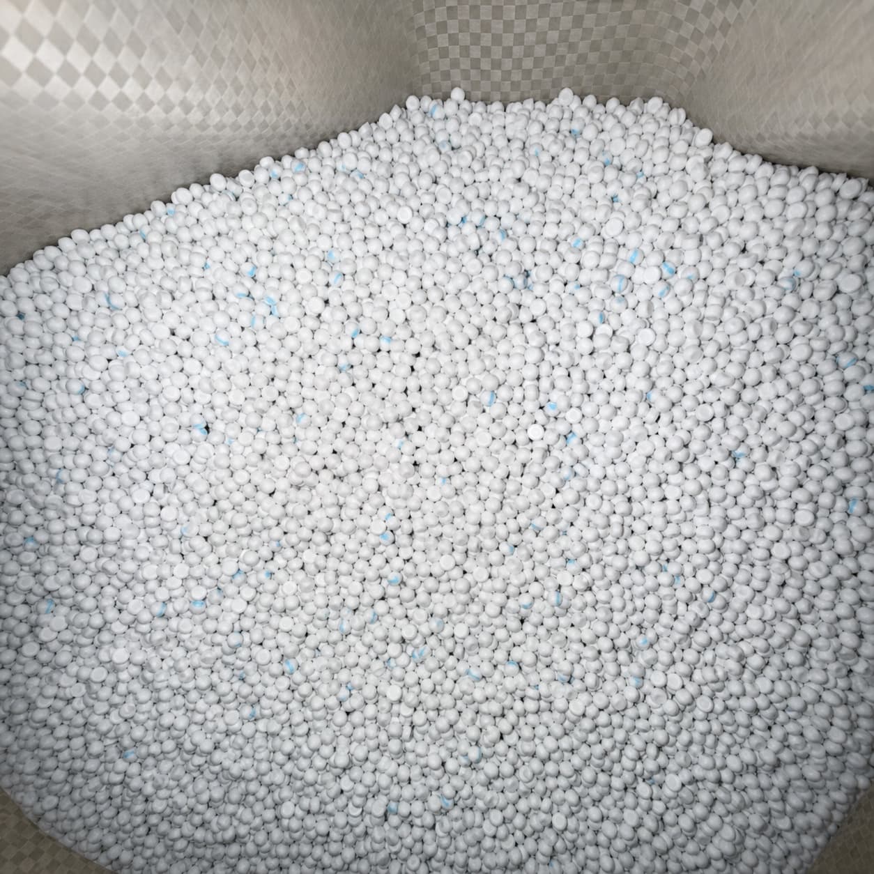 Bulk white cable compound pellets in storage
